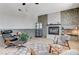 Bright living room with stone fireplace, hardwood floors, modern furniture and large windows providing natural light at 210 E Longacres Dr, Henderson, NV 89015