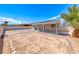 Backyard showcasing a solar panel roof, brick landscaping, with a partially covered patio area at 2103 Falcon Crest Ave, North Las Vegas, NV 89031