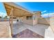 Spacious backyard with a covered patio and brick accents, perfect for entertaining or relaxing outdoors at 2103 Falcon Crest Ave, North Las Vegas, NV 89031