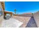 Fully bricked backyard, with covered patio, providing a low-maintenance, expansive area for outdoor activities and relaxation at 2103 Falcon Crest Ave, North Las Vegas, NV 89031
