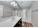 Bathroom with a spacious vanity, a large mirror, and a shower-tub combination with clean, bright finishes at 2103 Falcon Crest Ave, North Las Vegas, NV 89031