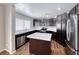 Updated kitchen with stainless steel appliances, tile countertops, and an island at 2103 Falcon Crest Ave, North Las Vegas, NV 89031