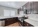 Kitchen sink with stainless steel appliances, and white tile countertops at 2103 Falcon Crest Ave, North Las Vegas, NV 89031