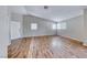 Bright living room with laminate wood flooring, fresh paint, and many windows at 2103 Falcon Crest Ave, North Las Vegas, NV 89031