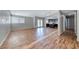 Open-concept living room with wood flooring flowing seamlessly into adjacent kitchen area at 2103 Falcon Crest Ave, North Las Vegas, NV 89031