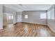 Spacious living room featuring laminate wood flooring, ample natural light, and neutral paint at 2103 Falcon Crest Ave, North Las Vegas, NV 89031