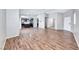 Stylish open-concept living area with laminated wood floors flowing seamlessly to kitchen at 2103 Falcon Crest Ave, North Las Vegas, NV 89031