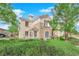 Beautifully landscaped two-story residence with a manicured lawn, mature trees, and serene ambiance at 2325 Windmill Pkwy # 1023, Henderson, NV 89074