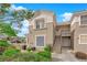 Attractive two-story home with neutral siding, well-maintained landscaping, and convenient stair access at 2325 Windmill Pkwy # 1023, Henderson, NV 89074