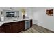 Stylish kitchen with stainless steel appliances, dark cabinets, and durable hard surface flooring at 2325 Windmill Pkwy # 1023, Henderson, NV 89074