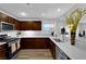 Modern kitchen with stainless steel appliances, stylish cabinets, and bright white countertops at 2325 Windmill Pkwy # 1023, Henderson, NV 89074