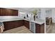 Modern kitchen with granite countertops, stainless steel appliances, and dark wood cabinetry and open floor plan at 2325 Windmill Pkwy # 1023, Henderson, NV 89074