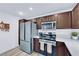 Bright kitchen with stainless steel appliances, dark cabinets, and stylish countertops at 2325 Windmill Pkwy # 1023, Henderson, NV 89074