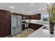 Modern kitchen featuring stainless steel appliances, granite countertops, and dark wood cabinets at 2325 Windmill Pkwy # 1023, Henderson, NV 89074