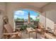 Cozy covered patio features ample seating and serene outdoor view, perfect for relaxing or entertaining at 2325 Windmill Pkwy # 1023, Henderson, NV 89074