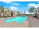 Community pool with pristine water, surrounded by well-maintained landscaping and multi-story residential buildings under a bright sky at 2325 Windmill Pkwy # 1023, Henderson, NV 89074