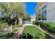 Beautiful backyard featuring lush landscaping, a sparkling pool, and an outdoor bar, perfect for relaxing and entertaining at 2345 Villandry Ct, Henderson, NV 89074