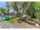Gathering-friendly backyard with a sparkling pool, slide, artificial grass and lounge seating to enjoy outdoors at 2345 Villandry Ct, Henderson, NV 89074