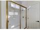 This modern bathroom features a glass enclosed shower with gold trim and brass fixtures at 2345 Villandry Ct, Henderson, NV 89074