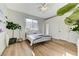 A bright bedroom featuring a metal bedframe, large window and plants at 2345 Villandry Ct, Henderson, NV 89074