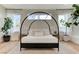 Bright bedroom featuring a unique four-poster bed, neutral tones, and large windows at 2345 Villandry Ct, Henderson, NV 89074