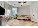 Bedroom with wood floors, mounted TV, and lots of natural light at 2345 Villandry Ct, Henderson, NV 89074
