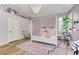 The bedroom has a four poster bed, wood floor, stuffed animals, and shuttered windows at 2345 Villandry Ct, Henderson, NV 89074