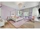 Well decorated bedroom with a chandelier, four poster bed, and pink area rug at 2345 Villandry Ct, Henderson, NV 89074