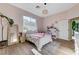 Bright bedroom with a large window, modern décor, and hardwood flooring at 2345 Villandry Ct, Henderson, NV 89074