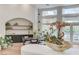 Cozy dining area with an archway, cabinets with a sink, and floor to ceiling windows overlooking the pool at 2345 Villandry Ct, Henderson, NV 89074
