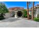 Elegant home entrance with stately columns, a covered porch, and a well-manicured garden at 2345 Villandry Ct, Henderson, NV 89074