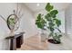 Bright entryway with wood floors, plantation shutters, decorative table, and potted plant at 2345 Villandry Ct, Henderson, NV 89074