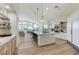 Open-concept kitchen featuring a large island, modern appliances, and a view into the dining and living areas at 2345 Villandry Ct, Henderson, NV 89074