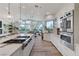 Bright kitchen with stainless steel appliances, an island cooktop, and views of the living and dining areas at 2345 Villandry Ct, Henderson, NV 89074