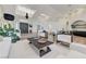 Bright, open living room featuring high ceilings, modern decor, and a stylish black coffee table and decorative plants at 2345 Villandry Ct, Henderson, NV 89074