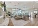 Bright living room with an open floor plan, large windows, and a stylish sectional sofa at 2345 Villandry Ct, Henderson, NV 89074