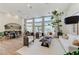 Spacious living room with floor to ceiling windows, white sofas, a modern coffee table and hardwood flooring at 2345 Villandry Ct, Henderson, NV 89074