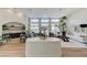 Bright living space boasting natural light from large windows, a dining area, and modern decor, with hardwood floors at 2345 Villandry Ct, Henderson, NV 89074
