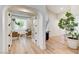 The view through french doors shows a living room with a sofa and two armchairs in front of a window at 2345 Villandry Ct, Henderson, NV 89074