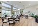 Open concept living and dining area with large windows, hardwood floors, modern furniture, and an open floorplan at 2345 Villandry Ct, Henderson, NV 89074