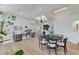 Open concept living and dining area with modern decor, comfortable seating, and natural light, connected by hardwood floors at 2345 Villandry Ct, Henderson, NV 89074