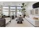 Bright living room boasting tall windows, modern decor, and a comfortable seating area at 2345 Villandry Ct, Henderson, NV 89074