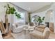 A well-decorated living room features a white sofa, two armchairs, a mirror, and natural light at 2345 Villandry Ct, Henderson, NV 89074