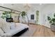 A stylish main bedroom features a canopy bed, modern lighting, and a view into the rest of the house at 2345 Villandry Ct, Henderson, NV 89074