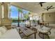 Back patio with pillars overlooks pool and greenery with seating options and ceiling fans at 2345 Villandry Ct, Henderson, NV 89074