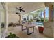 This covered patio overlooks a backyard pool and palm trees at 2345 Villandry Ct, Henderson, NV 89074
