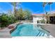 Beautiful backyard pool and spa with lush tropical landscaping creating a backyard paradise at 2345 Villandry Ct, Henderson, NV 89074
