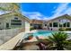 Clean pool design with lush tropical landscaping creating a backyard paradise at 2345 Villandry Ct, Henderson, NV 89074