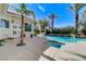 Backyard pool and spa area features a waterfall, outdoor bar, and lush landscaping, creating a resort-like feel at 2345 Villandry Ct, Henderson, NV 89074