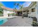 Inviting backyard pool and spa with covered patio and palm trees create a private retreat at 2345 Villandry Ct, Henderson, NV 89074